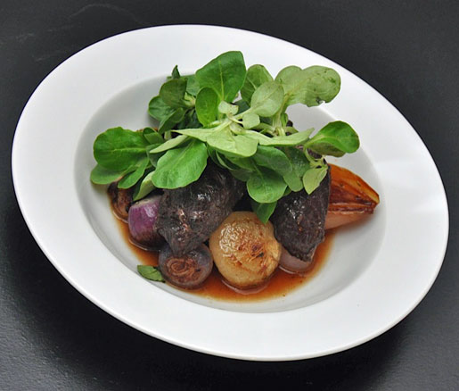 Chef Sondra Bernstein's recipe for braised pork cheeks with three-onion ragoût, adapted by the James Beard Foundation